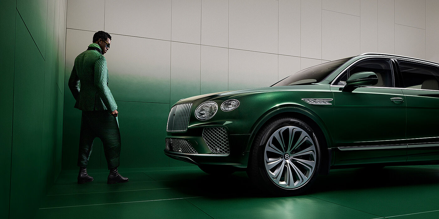 Bentley Hamburg Wisdom K standing next to Bentley Bentayga Extended Wheelbase SUV in Light Emerald green paint in profile
