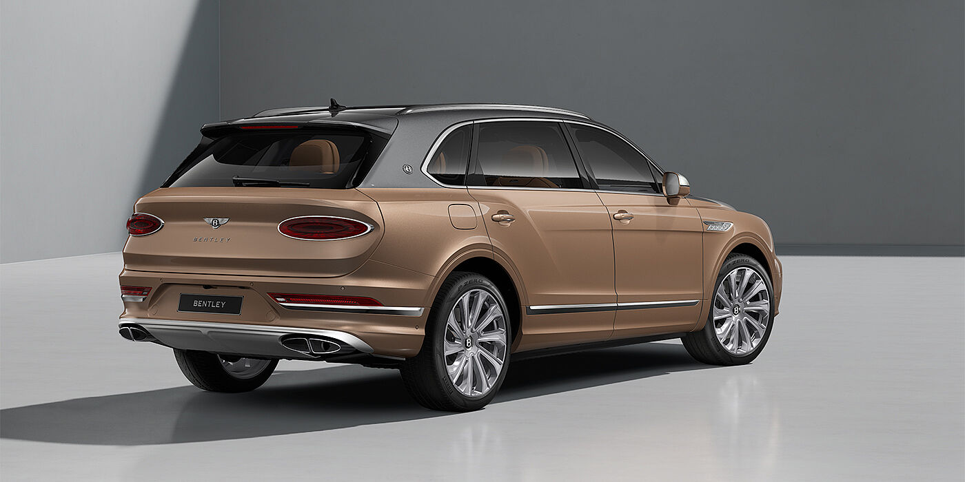 Bentley Hamburg Bentley Bentayga EWB Mulliner SUV in Magnetic and Rose Gold paint and 22" Mulliner wheels rear ¾
