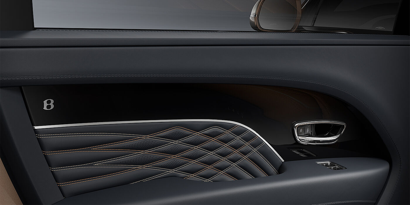 Bentley Hamburg Bentley Bentayga EWB Mulliner SUV door interior detail in Brunel hide and Grand Black veneer with Mulliner contrast stitching