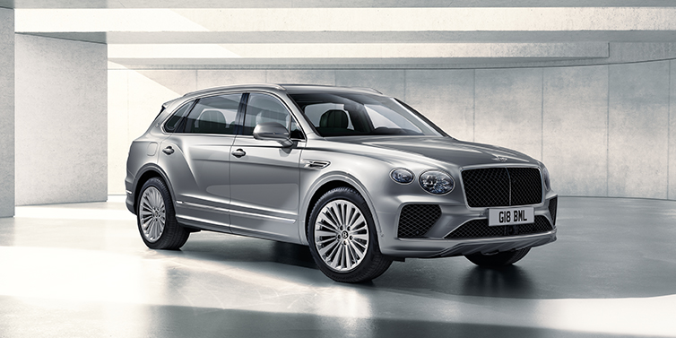Bentley Hamburg Bentley Bentayga Extended Wheelbase SUV front three quarter in Moonbeam paint with a grey background