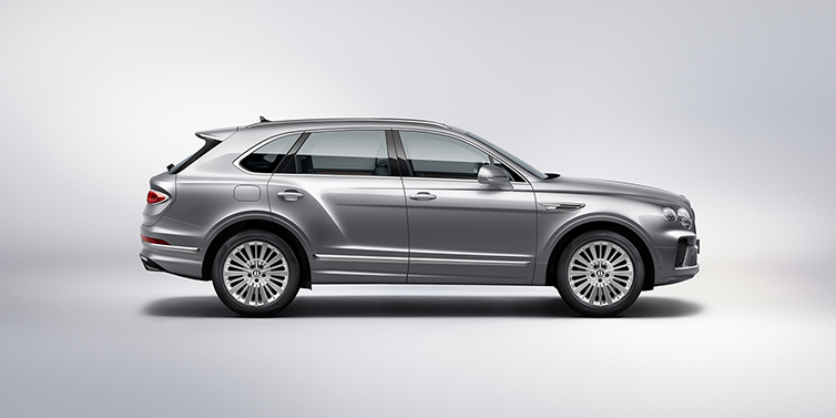Bentley Hamburg Bentley Bentayga SUV side profile in Moonbeam silver paint against white background featuring 21 inch 5 spoke wheels