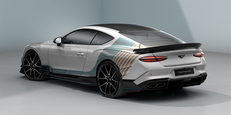 Bentley Hamburg Bentley Supersports rear three quarter in "Snowstorm" Design theme with Snow Quartz paint and Topaz blue and Camel brown paint stripes across the rear haunch.